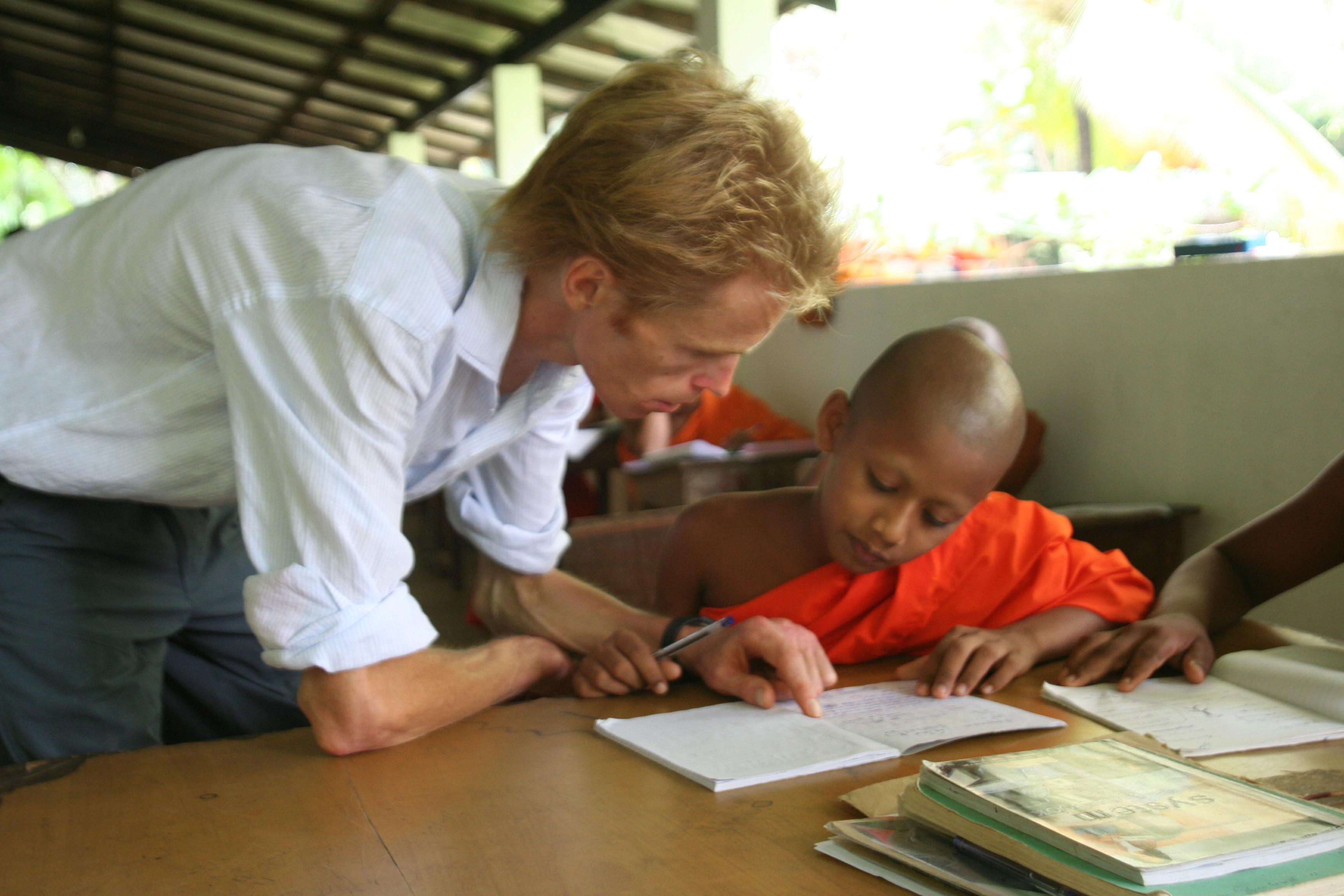 A young monk receives help from a volunteer teaching English in Sri Lanka A young monk receives help from a volunteer teaching English in Sri Lanka
